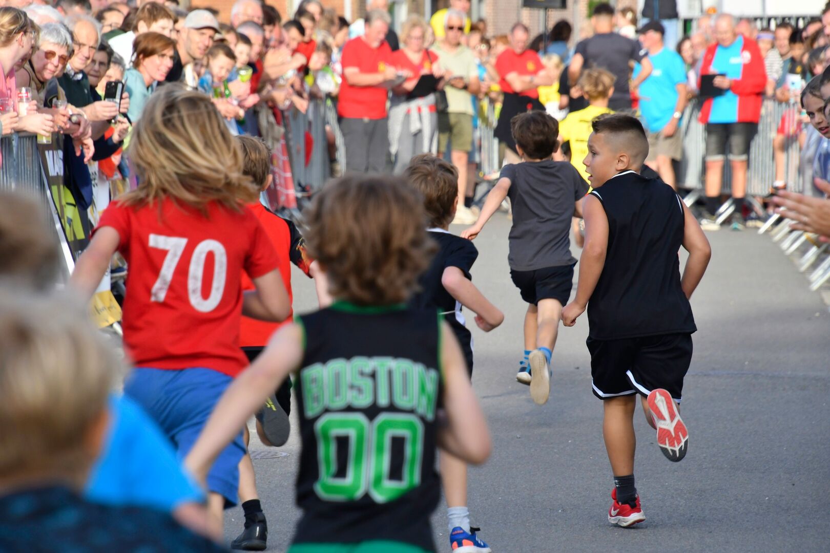 Jongens lopen tussen de supporters
